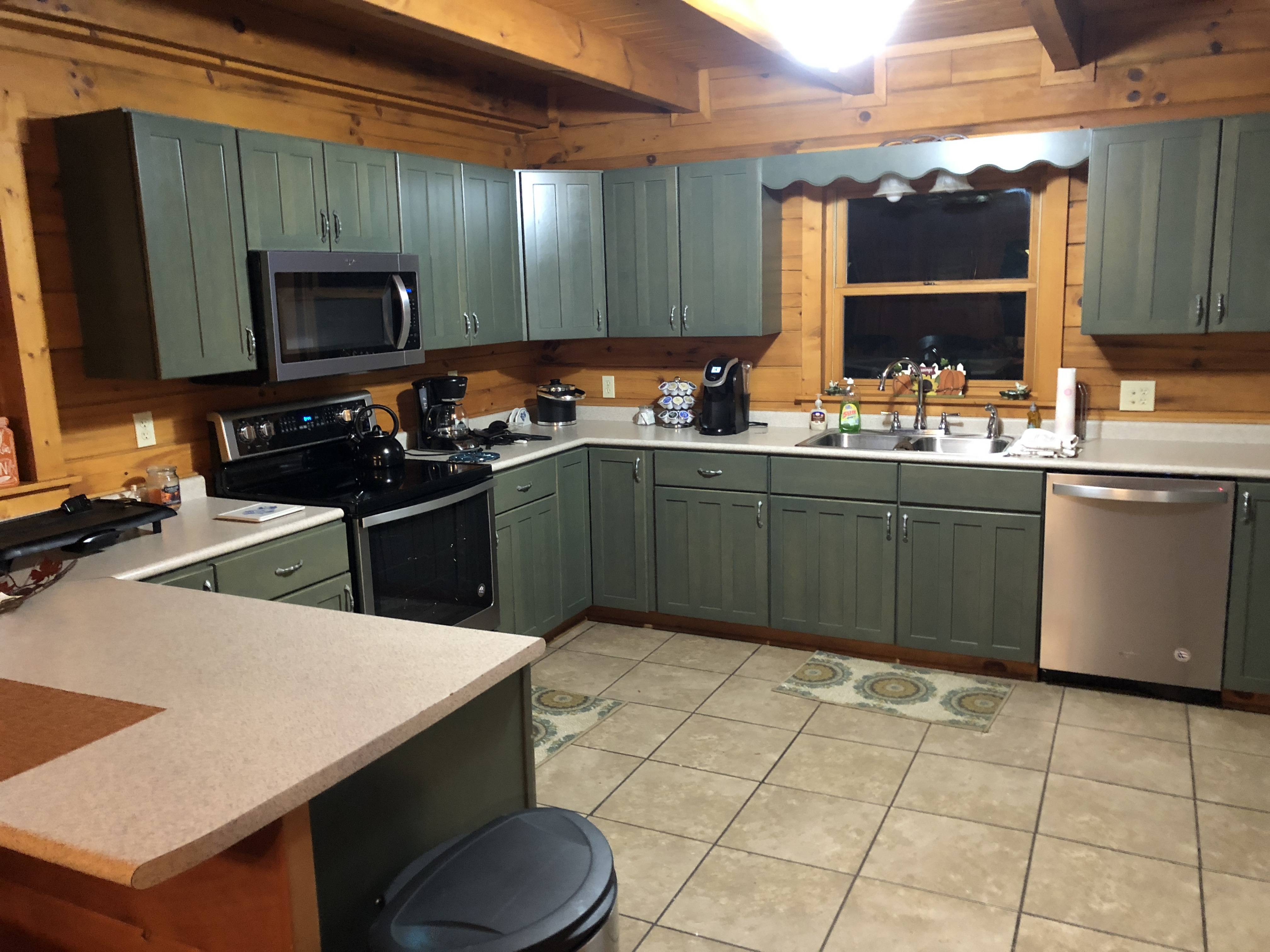 Kitchen with Stainless Appliances & Counter Bar + 2 Stools